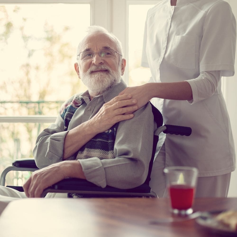 A nurse comforting a woman sitting on a bed.
