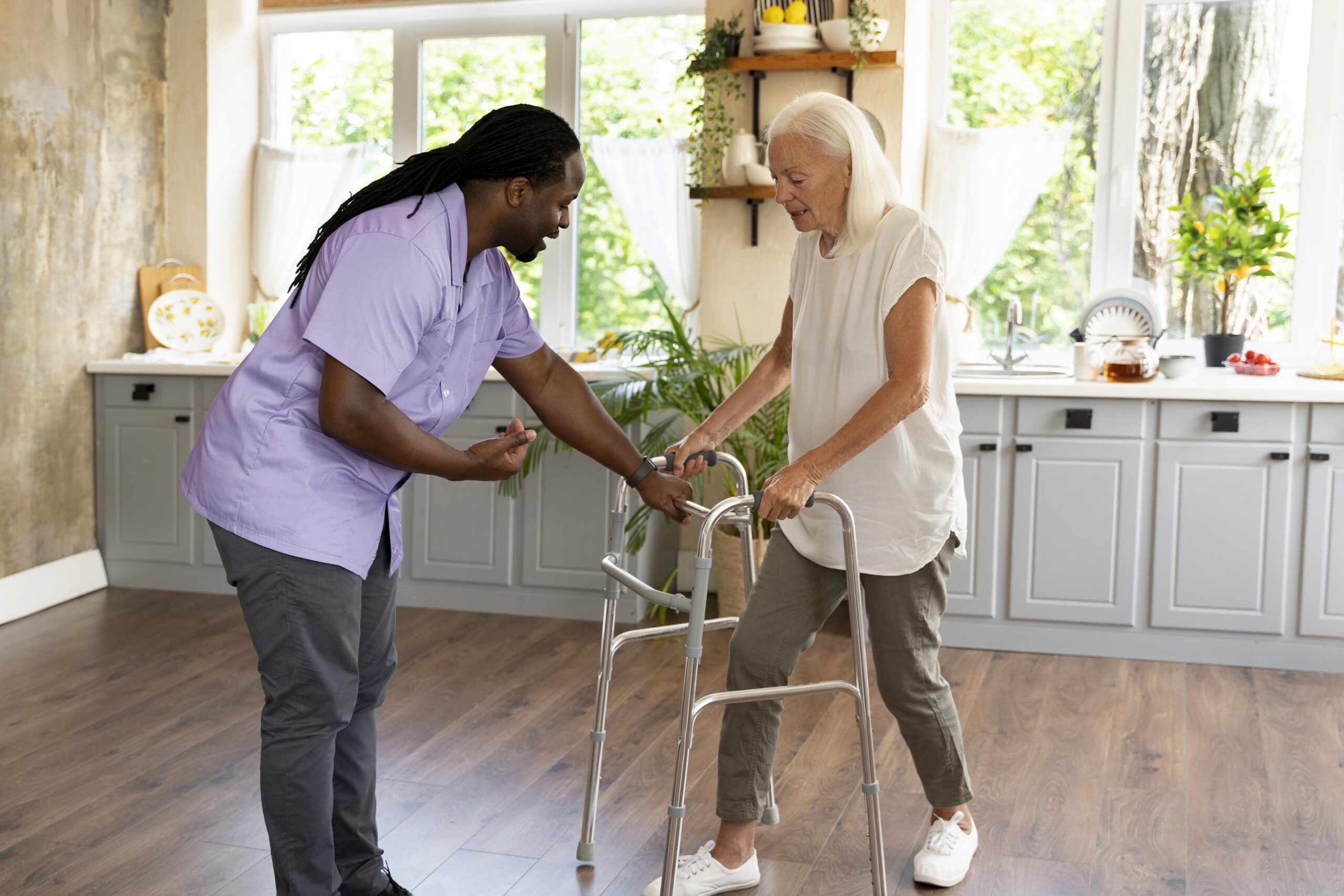 TRU Star caregiver assisting a senior in walking using a walker