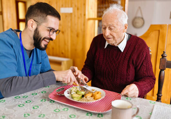 Home caretaker – man helping senior man
